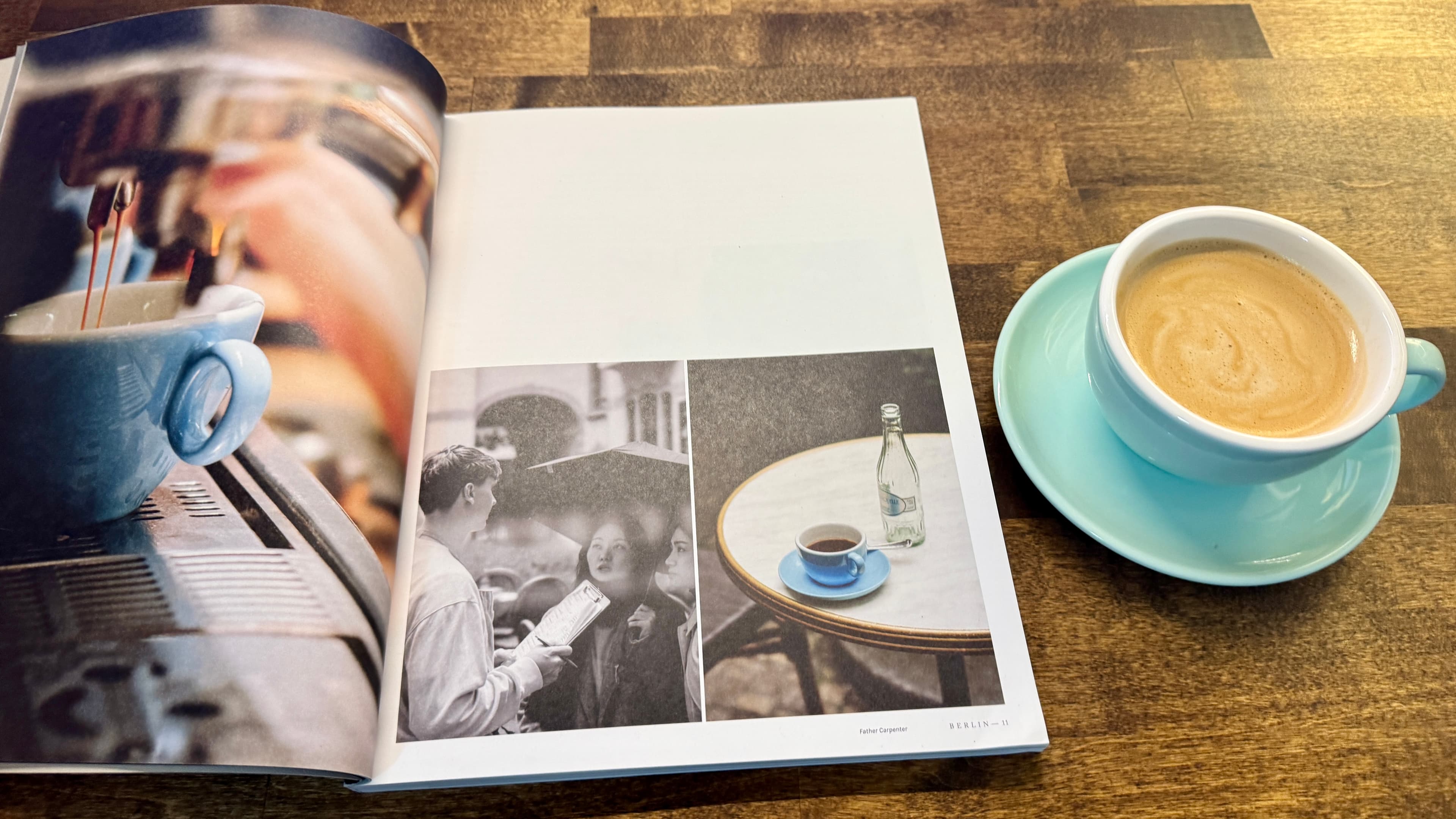 A cup of coffee next to an open magazine